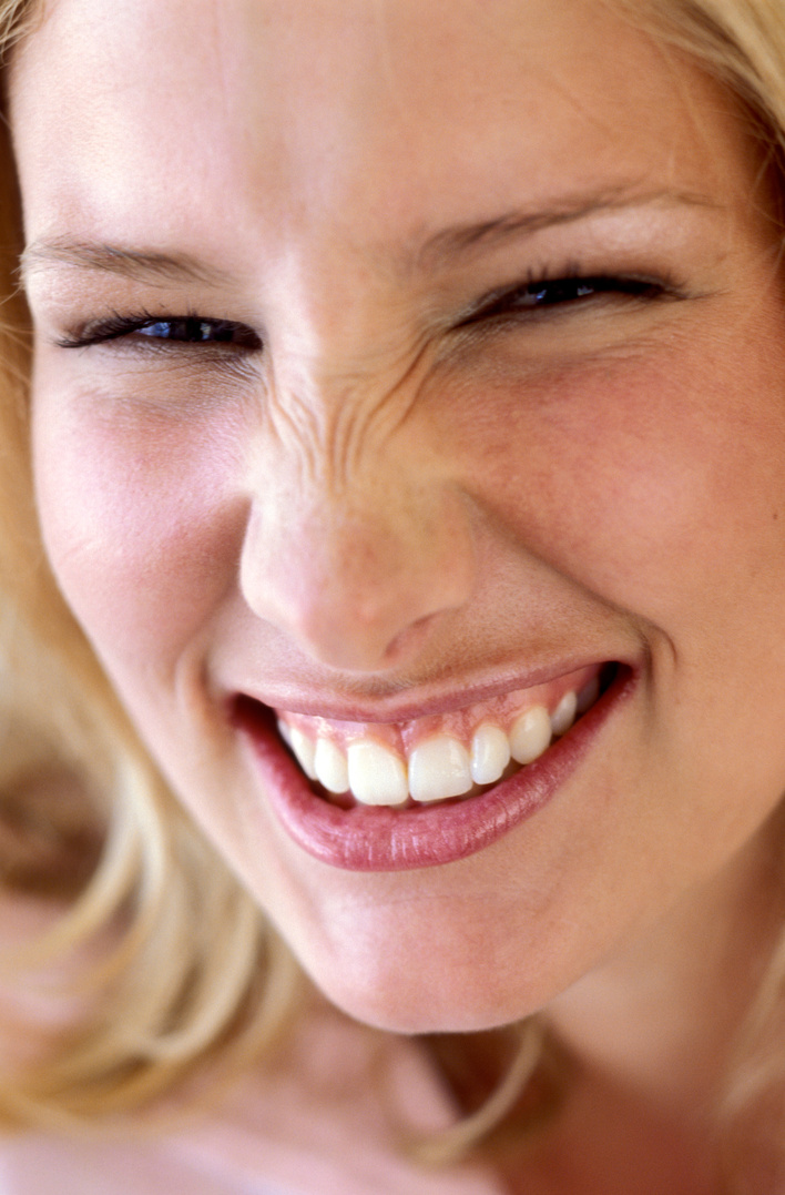 Smiling woman wrinkling nose